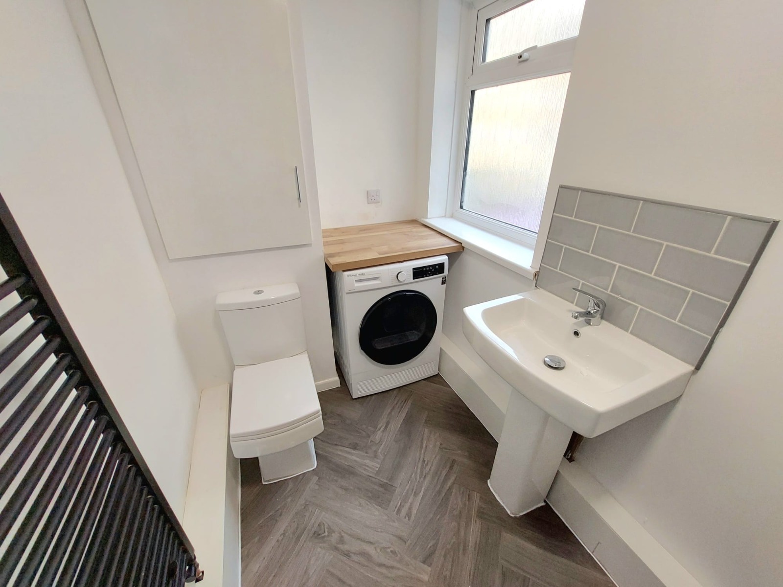 White bathroom with grey subway tiling