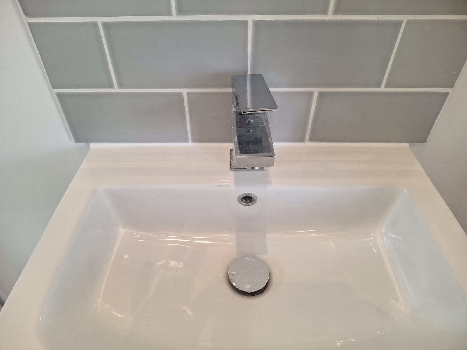 Close up of square chrome tap